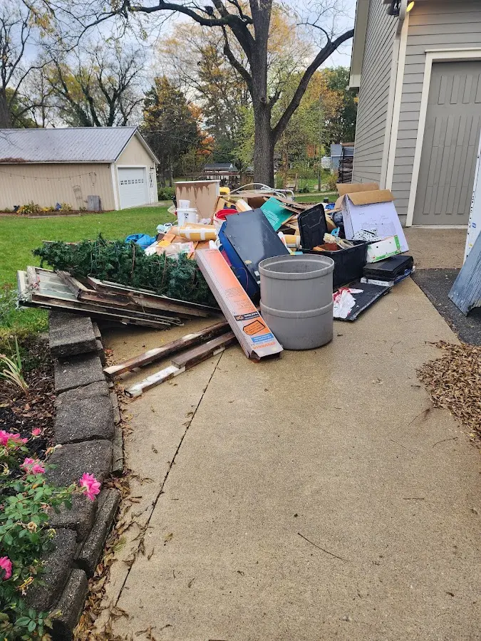 Dumpster being loaded with debris for Roofing Dumpster Rental in South Strabane